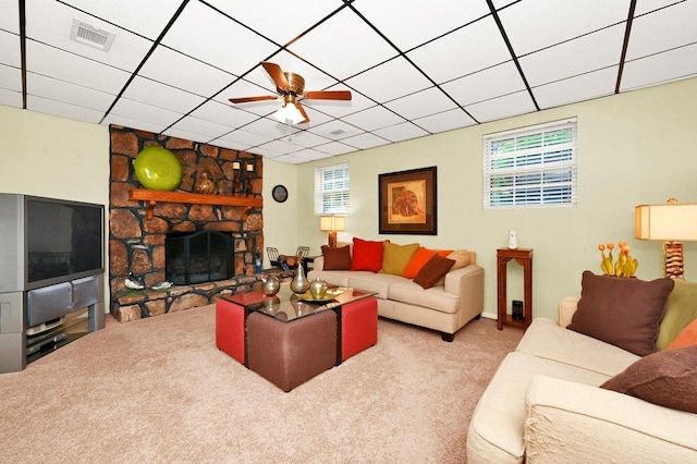 carpeted living room featuring a paneled ceiling, ceiling fan, and a fireplace