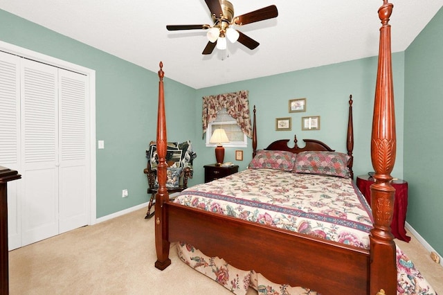 carpeted bedroom with ceiling fan and a closet