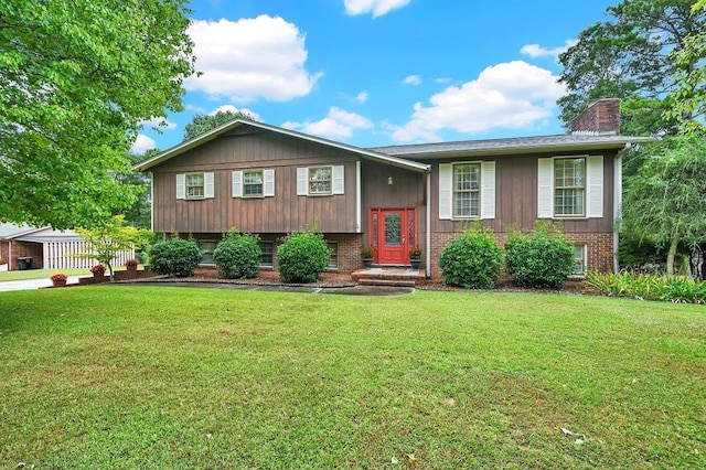 raised ranch with a front lawn