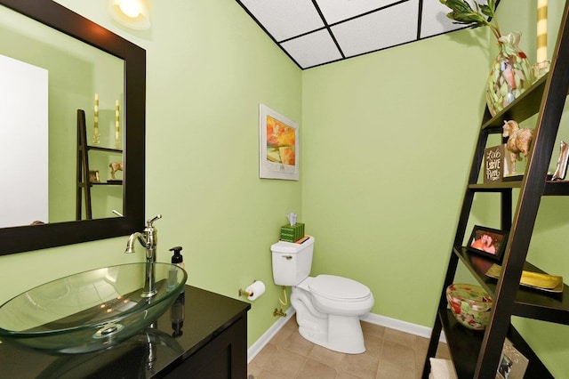 bathroom featuring tile patterned floors, vanity, and toilet