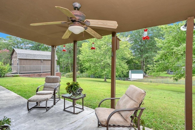 view of patio / terrace with ceiling fan and a storage shed