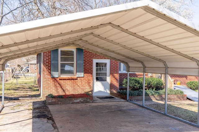 view of car parking featuring a detached carport and fence