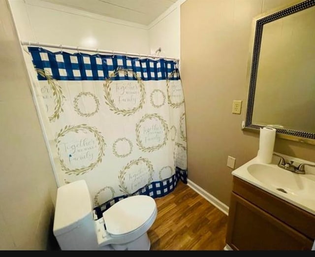 bathroom with vanity, crown molding, a shower with shower curtain, toilet, and wood-type flooring