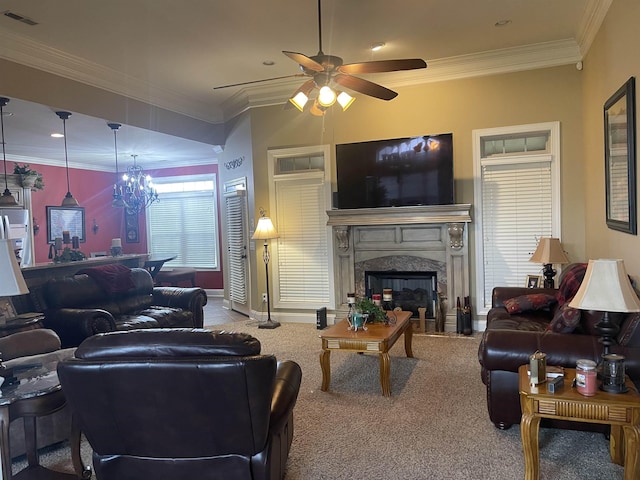 living room featuring a premium fireplace, crown molding, carpet flooring, and ceiling fan with notable chandelier