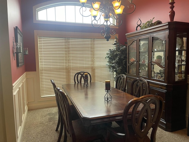 dining room with an inviting chandelier and light carpet