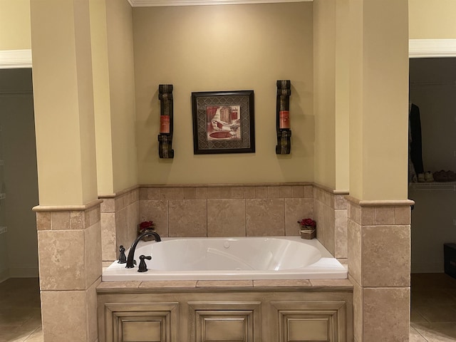 bathroom featuring tile patterned flooring, a tub to relax in, and tile walls