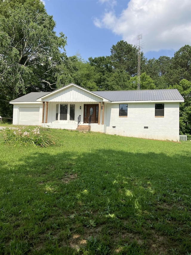 120 Maple St, Cherokee, AL - view of front of house featuring a front yard, metal roof, a garage, and cooling unit