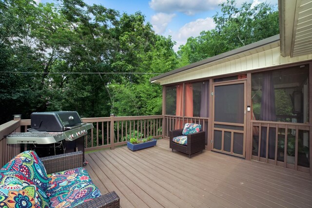  - wooden terrace with grilling area, a sunroom, and view of scattered trees