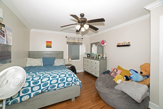  - bedroom featuring ornamental molding, wood finished floors, and a ceiling fan