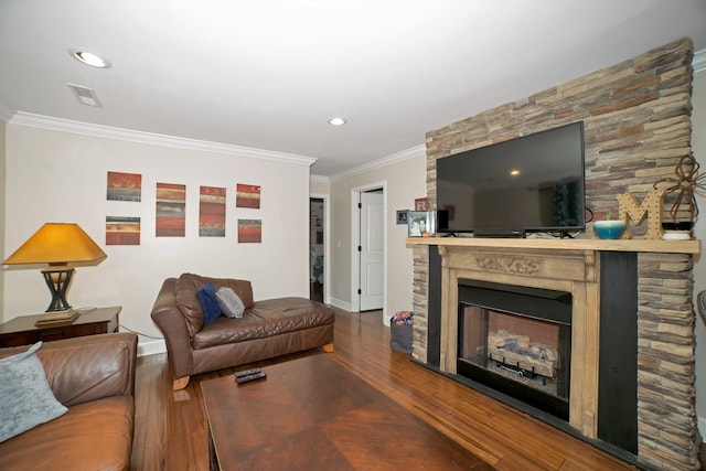  - living room with wood finished floors, ornamental molding, a fireplace, and recessed lighting