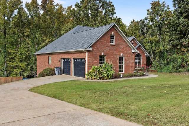 view of home's exterior with a garage, driveway, a lawn, roof with shingles, and brick siding