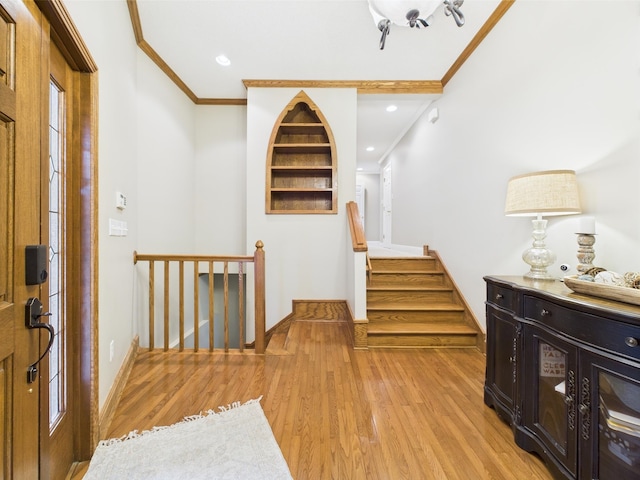  - entryway with crown molding, light wood finished floors, baseboards, stairs, and recessed lighting