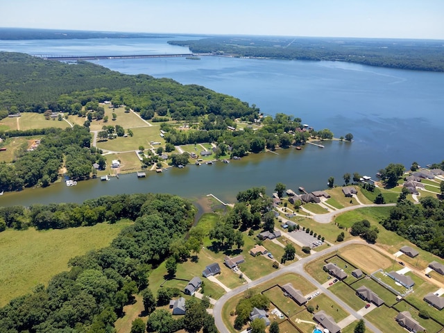 aerial view with a water view and a wooded view