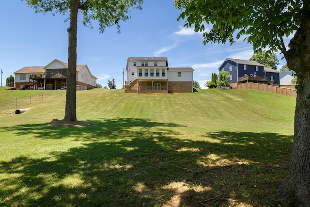 view of yard with fence and stairway