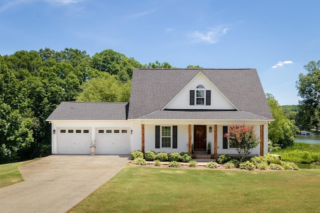 view of front of property featuring a garage, driveway, roof with shingles, a porch, and a front yard