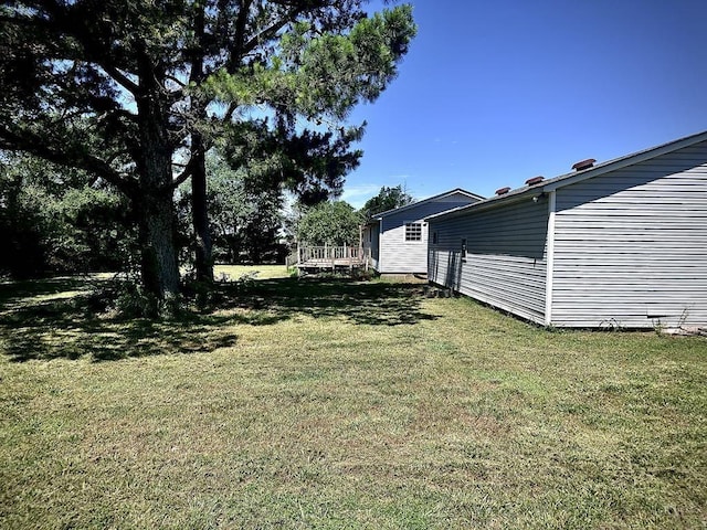  - view of green lawn with a wooden deck