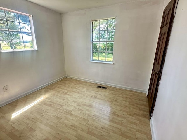  - unfurnished room featuring light wood-style floors and baseboards
