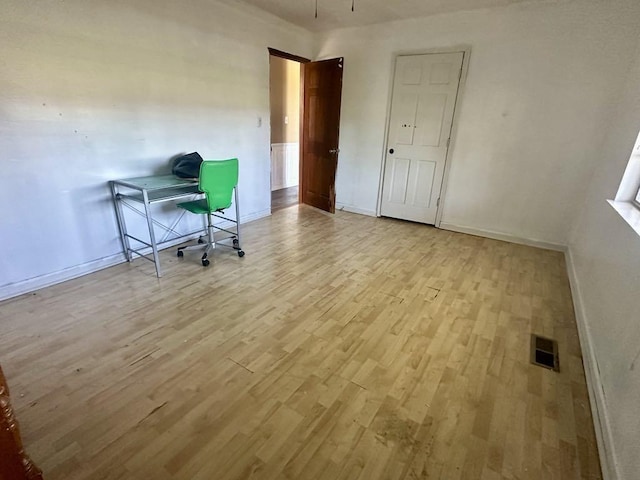  - office space featuring wood finished floors and baseboards