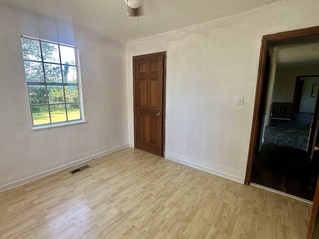  - empty room with light wood-type flooring, baseboards, and a ceiling fan