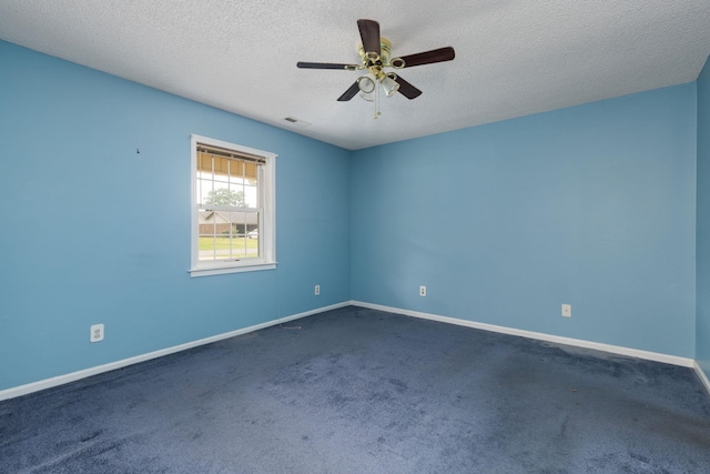  - empty room featuring dark carpet, baseboards, a textured ceiling, and ceiling fan