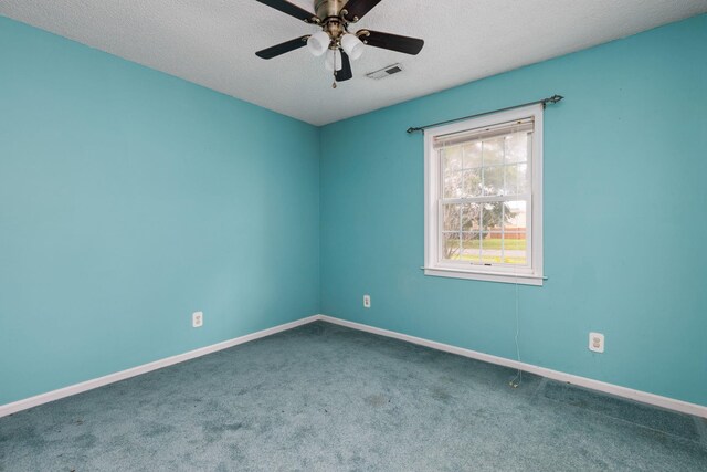  - spare room featuring carpet, a ceiling fan, baseboards, and a textured ceiling