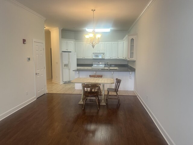  - dining space with a chandelier, wood finished floors, and crown molding
