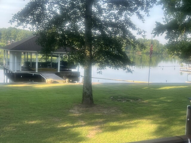  - view of green lawn with a water view
