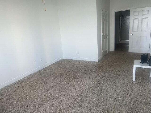  - unfurnished room featuring carpet flooring and baseboards