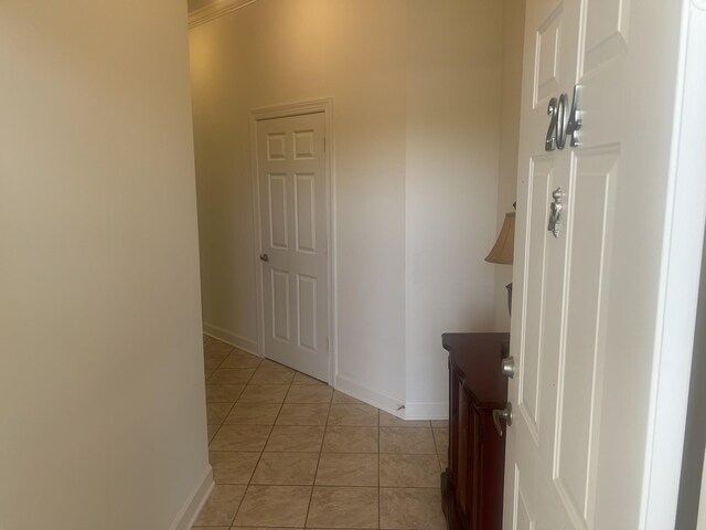  - hallway with light tile patterned floors and baseboards