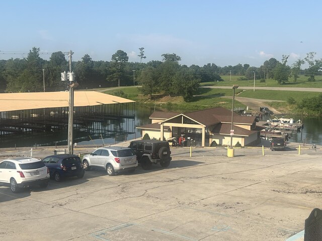  - uncovered parking lot with a water view