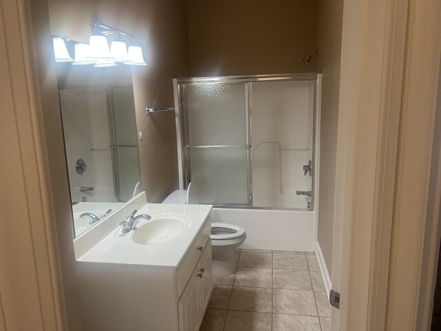  - bathroom featuring vanity, combined bath / shower with glass door, and tile patterned floors