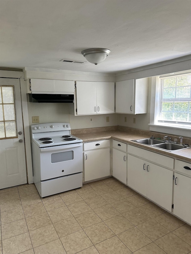 kitchen featuring white cabinetry, light tile patterned flooring, electric stove, and sink