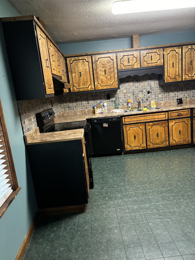 kitchen with tasteful backsplash, brown cabinetry, a sink, black appliances, and baseboards