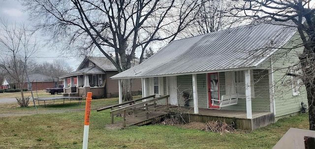 view of front of home featuring a trampoline and a front yard