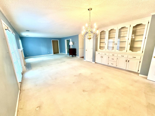 interior space with a textured ceiling and a notable chandelier