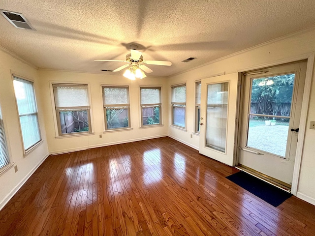 unfurnished sunroom with ceiling fan