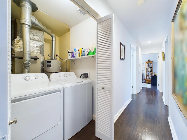 clothes washing area with washer and clothes dryer and dark hardwood / wood-style floors