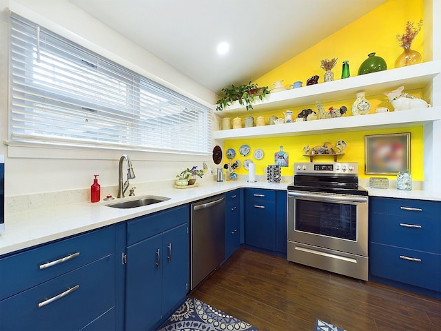 kitchen featuring appliances with stainless steel finishes, vaulted ceiling, dark wood-type flooring, sink, and blue cabinetry