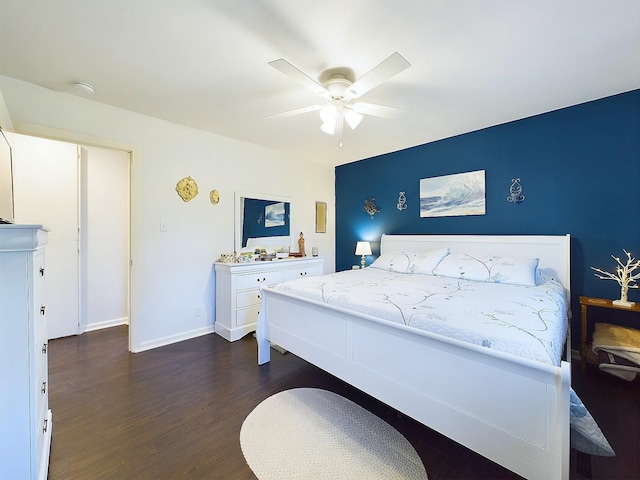 bedroom with ceiling fan and dark wood-type flooring