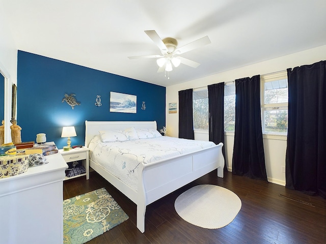 bedroom with ceiling fan and dark wood-type flooring