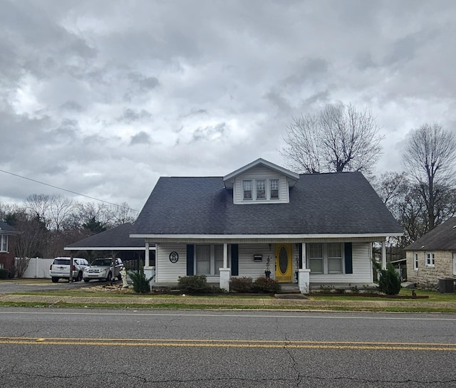 view of front of home with central AC and a carport