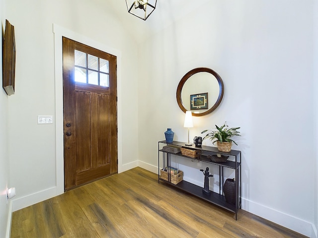 foyer with hardwood / wood-style floors and lofted ceiling