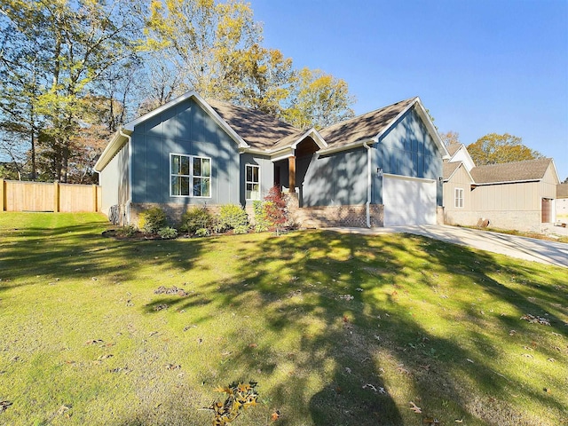 view of front of house with a garage and a front lawn