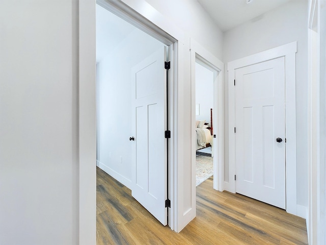 hallway with hardwood / wood-style floors