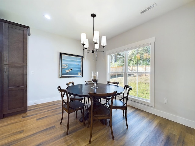 dining room featuring a chandelier and dark hardwood / wood-style floors