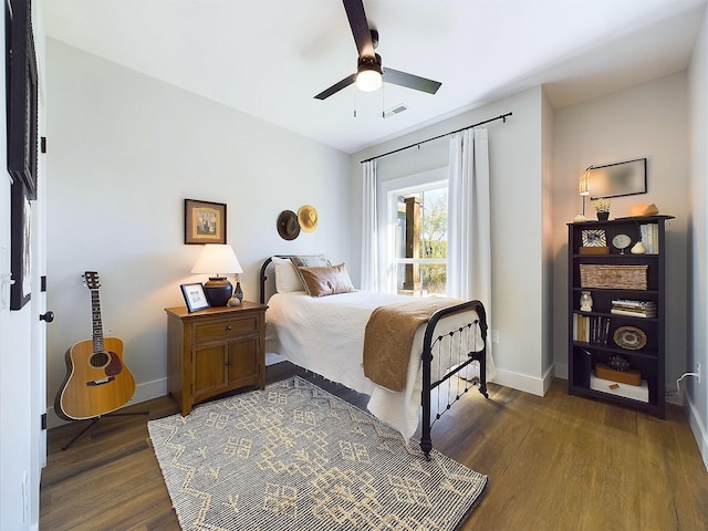 bedroom with ceiling fan and dark hardwood / wood-style floors