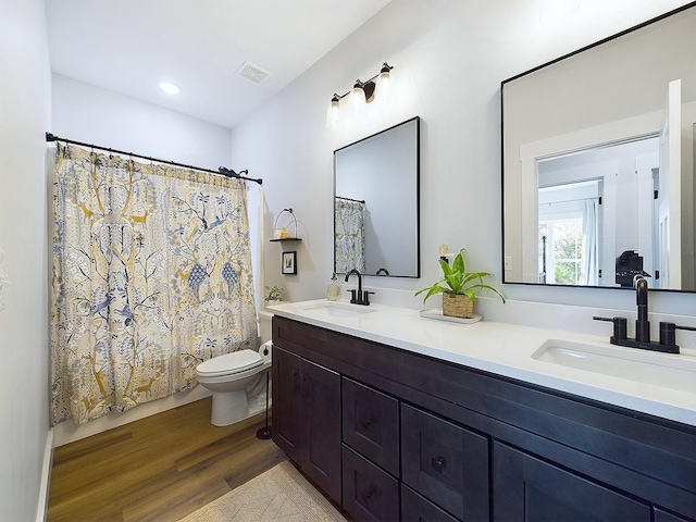 full bathroom featuring wood-type flooring, vanity, toilet, and shower / bath combo