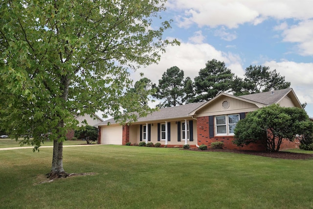 ranch-style house with a front yard, brick siding, and an attached garage