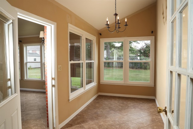 unfurnished sunroom featuring an inviting chandelier and vaulted ceiling