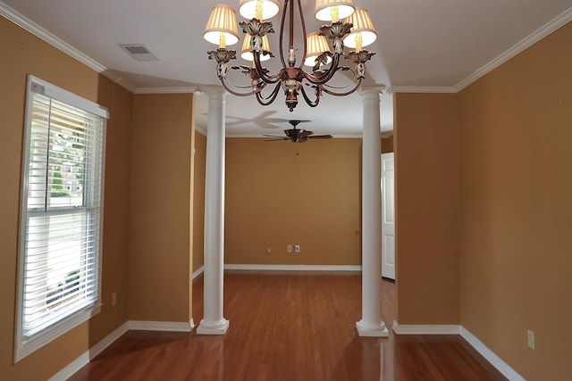 unfurnished dining area featuring ceiling fan with notable chandelier, ornamental molding, decorative columns, and wood-type flooring